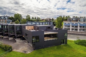 A modern building with multiple floors, large windows, and a flat roof.