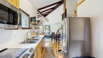 A compact kitchen with modern appliances, a built-in oven, and a stainless steel refrigerator.