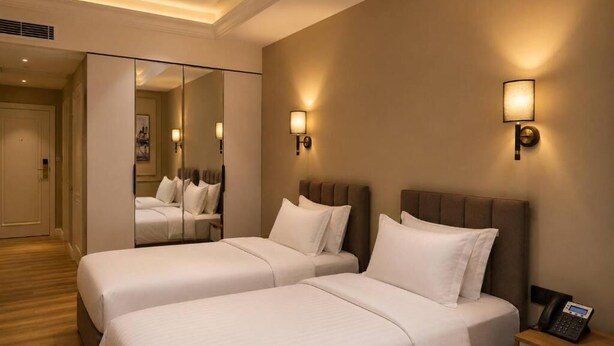 A hotel room with two beds, a bedside table with a phone, and a mirror. - Amanat Prestige Hotel (Samarkand)