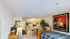 A compact room with a bed, a desk, a chair, and a kitchenette. - Slopeside Studio at Alyeska w/ Full Kitchen (Girdwood)