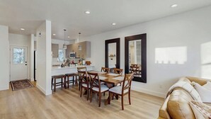 A modern interior with a dining area, kitchen, and living space.