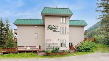 A two-story building with a green roof and a sign that reads 'Alaska NORTH.'