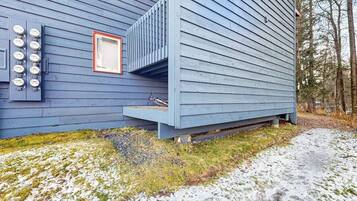A blue building with a small porch and a window.