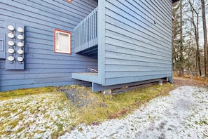 A blue building with a small porch and a window.