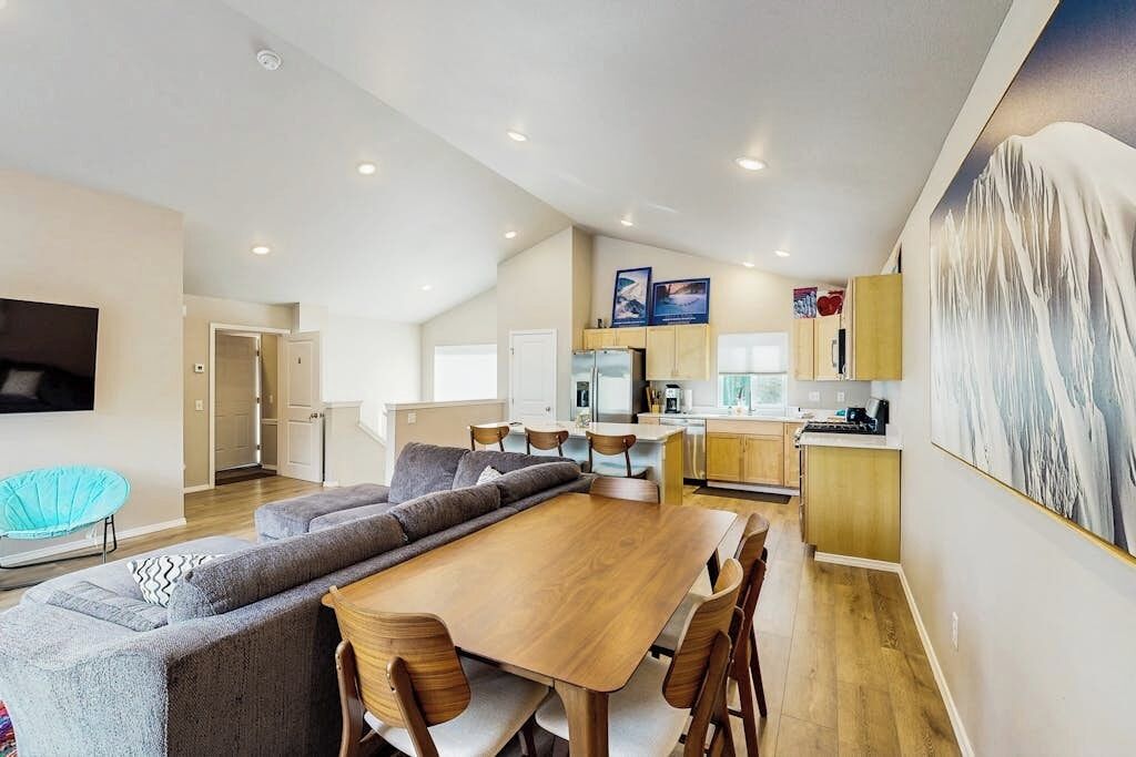A modern interior with a dining area, kitchen, and living space.