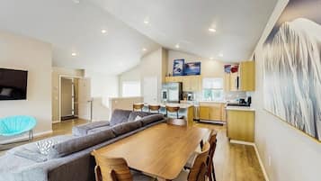 A modern interior with a dining area, kitchen, and living space.