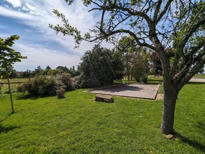 A grassy park area with a paved square, trees, and a clear sky. - Country house in Lourouer-Saint-Laurent (Lourouer-Saint-Laurent)