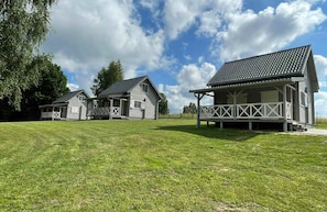A residential property with two houses, each with a porch and a covered area.