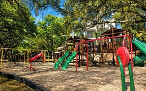 A playground with slides and climbing structures. - Ocean Villas A246-Professionally Managed by HHIB&T Vacation Rentals (Hilton Head Island)