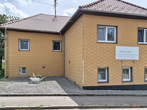 A two-story building with a sign indicating it is a residential property.