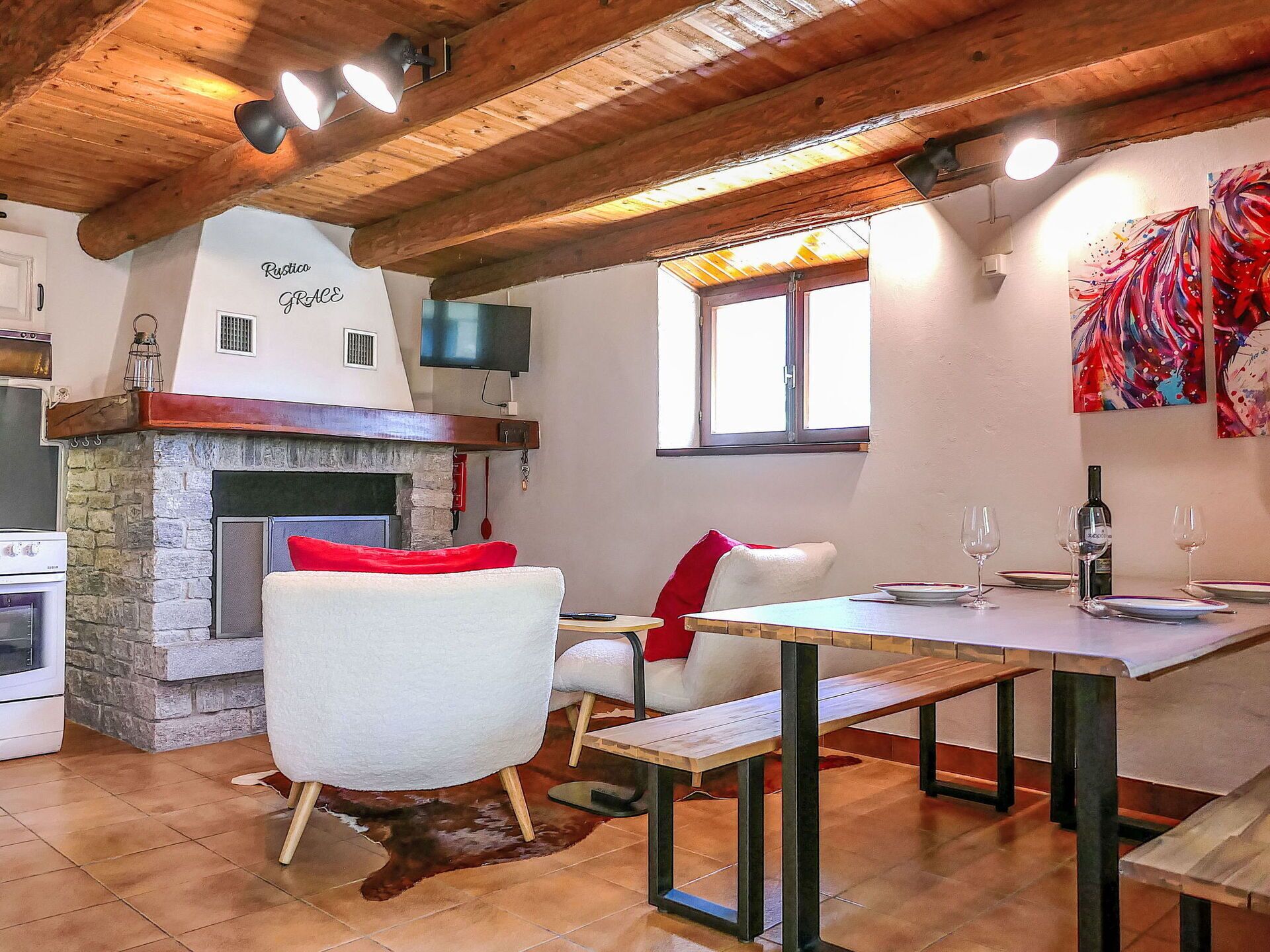 A rustic interior with a stone fireplace, a dining table, and a cozy seating area.