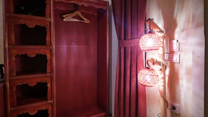A wooden wardrobe with multiple shelves and a hanging space. - Uçhisar Palace in Cappadocia Hotel (Nevsehir)