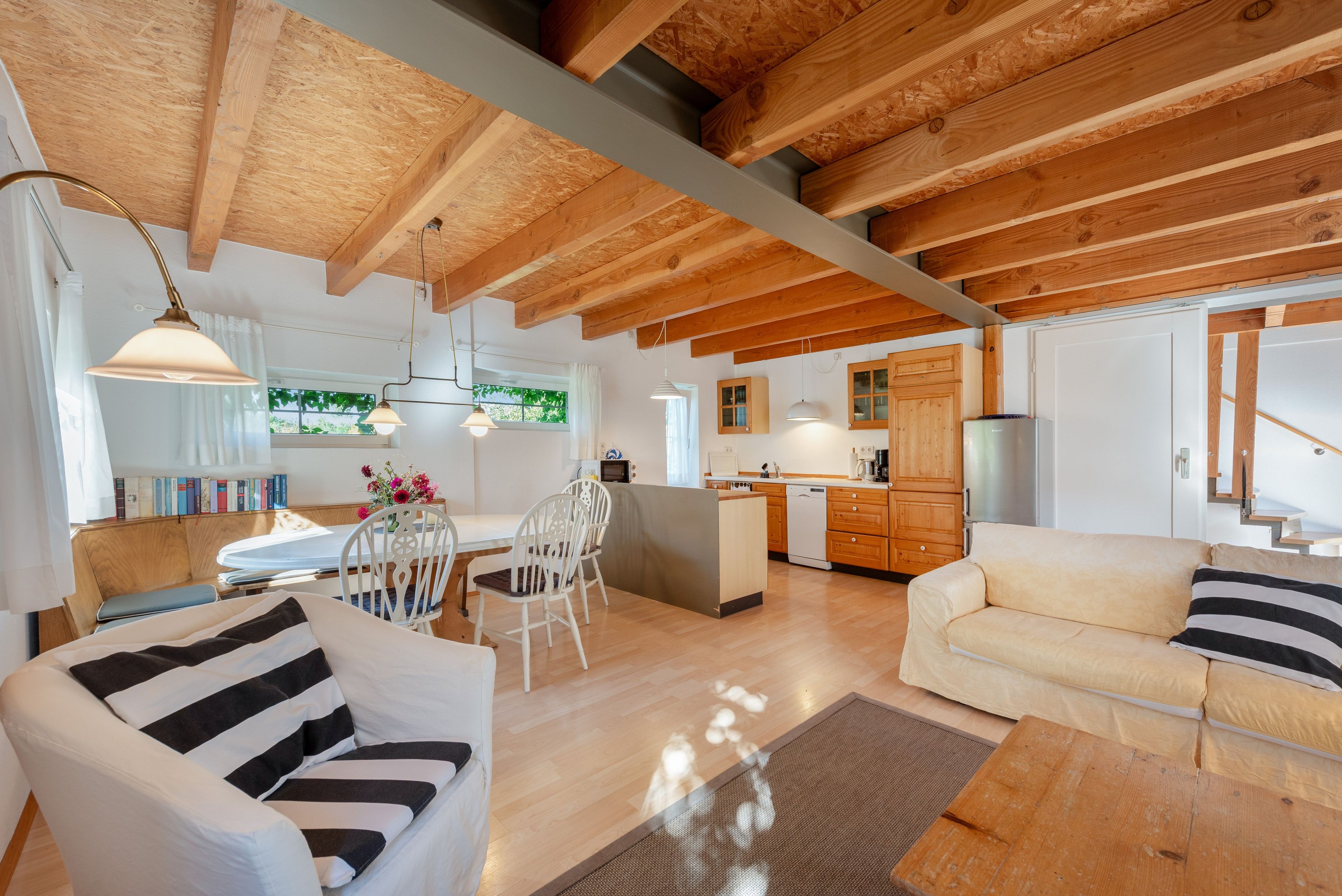 A modern interior with a dining area, kitchen, and seating space.