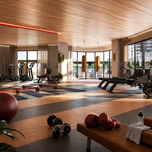 A gym with cardio machines, free weights, and a bench. - Sea & Skyline Views | Pool, Gym & Sauna (Southbank)