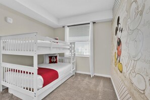 A child's bunk bed with a red mattress, white bedding, and a Mickey Mouse pillow. - Last Minute Disney Getaway! Themed Bedrooms & Private Balcony. Book Now! #109493 (Orlando)