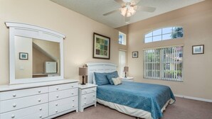 A bedroom with a bed, dresser, nightstands, and a ceiling fan. - Last Minute Disney Getaway! Townhouse with Private Pool. Book Now! #109037 (Orlando)
