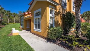 A yellow house with a number 2764, surrounded by greenery and a clear sky. - Last Minute Disney Getaway! Townhouse with Private Pool. Book Now! #109037 (Orlando)
