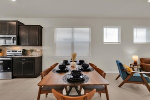 A dining area with a wooden table set for six, surrounded by dark wooden chairs. - Last Minute Disney Getaway! Luxury Villa with Private Pool. Book Now! #112733 (Orlando)