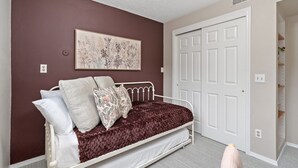 A bedroom with a bed, a door, and a wall-mounted artwork. - Pipit Place - Pet-friendly Home w/ Fenced Yard (Fort Collins)