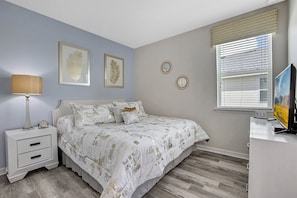 A bedroom with a bed, nightstand, lamp, and a window with blinds. - Last Minute Disney! Private Pool, Hot Tub, Game Room & Themed Bedrooms. Book Now! #116123 (Orlando)