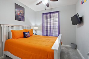 A bedroom with a bed, a ceiling fan, a window with purple curtains, a wall-mounted TV, and a radiator. - Last Minute Disney Getaway! Luxury Condo with Private Balcony. Book Now! #108399 (Orlando)