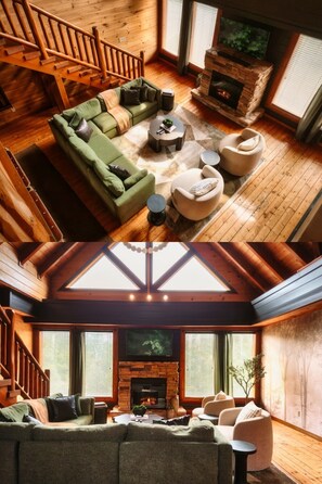 A cozy cabin interior with a wooden staircase, a green sofa, a fireplace, and a television. - Fall Smokies Retreat: Theater, Fireplaces & Hot Tub Across 4 Levels (Sevierville)