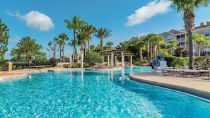 A swimming pool with a pergola, palm trees, and a covered seating area. - Last Minute Disney! Private Pool, Hot Tub, Game Room & Themed Bedrooms. Book Now! #136451 (Orlando)