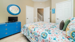 A bedroom with a bed, a dresser, a television, and a mirror. - Windsor Palms 93 - Three Bedroom House, Sleeps 6 (Orlando)