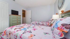 A bedroom with two beds, a dresser, a television, and a mirror. - Last Minute Disney Getaway! Private Pool, Hot Tub & Game Room. Book Now! #36218 (Orlando)