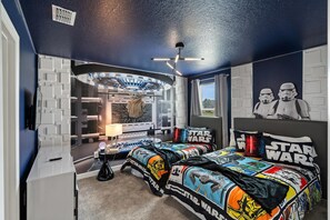 A Star Wars-themed bedroom with a bed, Star Wars posters, and a unique ceiling design. - Championsgate 897 - Ten Bedroom Villa, Sleeps 33 (Orlando)