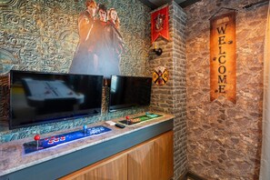 A wall with a welcome sign, two flat-screen TVs, and a pool table. - Championsgate 923 - Eight Bedroom Villa, Sleeps 20 (Orlando)
