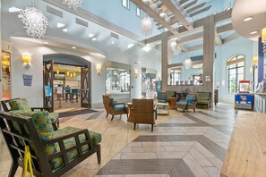 A spacious lobby with high ceilings, modern lighting, and comfortable seating areas. - Championsgate 994 - Six Bedroom Villa, Sleeps 14 (Orlando)