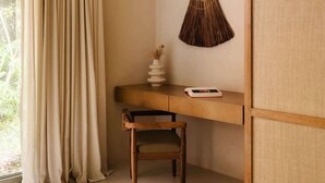 A room with a desk, chair, and an air conditioning unit. - Aflora Moon 3 bd First FloorBeach Club + Breakfast (Tulum)