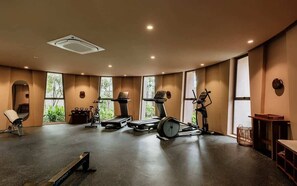 A gym with exercise equipment, large windows, and a ceiling vent. - Aflora Onyx Loft L224 Beach Club  + Breakfast (Tulum)