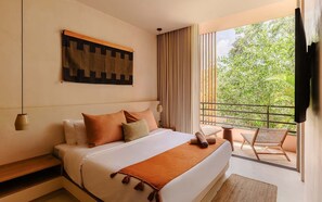 A hotel room with a bed, a view of greenery, a balcony with seating, and a painting on the wall. - Aflora Onyx Loft L224 Beach Club  + Breakfast (Tulum)