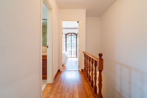 A hallway with wooden flooring leading to a room with a window and a door. - Cubo's El Refugio de Elviria House / communal pool / air conditioning / terrace / free Wi-Fi (Marbella)