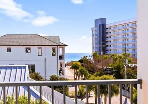 A hotel with a view of the ocean, a balcony, and a building with balconies.