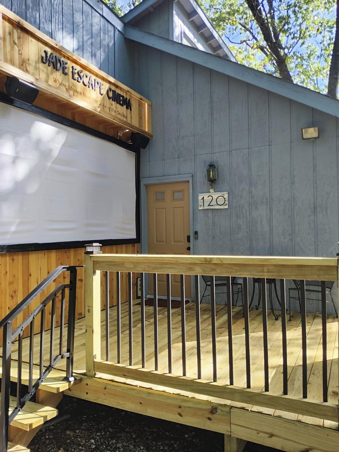 A wooden building with a sign reading 'JADE ESCAPE CINEMA' and a door labeled '120'.