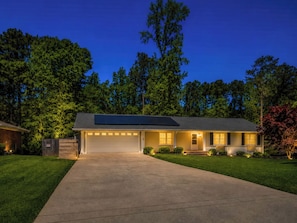 A single-story house with a garage, solar panels, and a well-maintained lawn. - Tucked away in Tucker (Tucker)