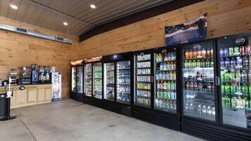 A vending area with Pepsi and Coca-Cola coolers, a coffee machine, and a gumball machine.