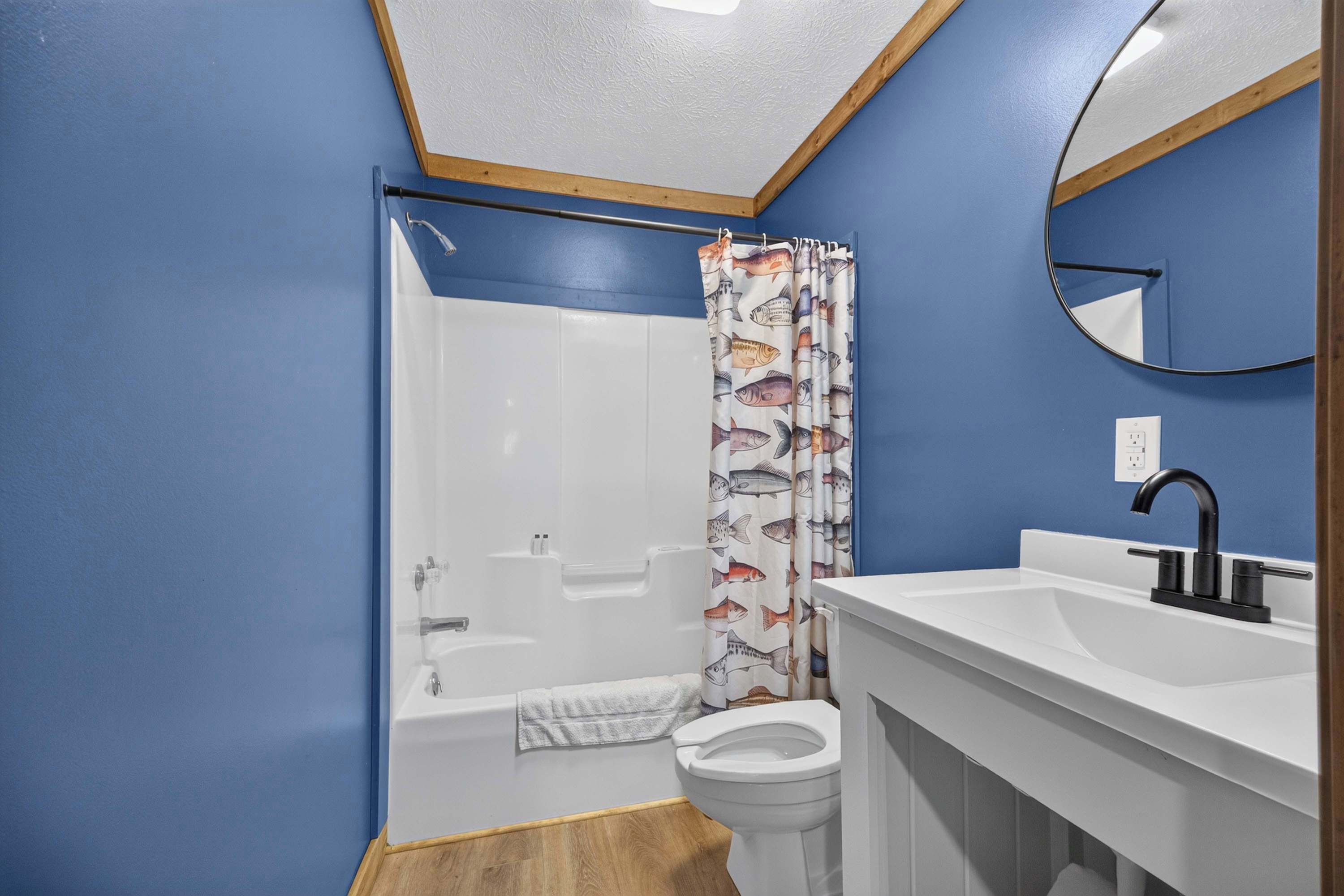 A bathroom with a bathtub, toilet, and sink.