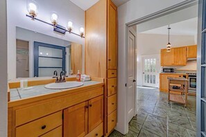 A bathroom with a wooden vanity, a large mirror, and a sink. - The Pool House - Private Pool & Relaxing Outdoor Retreat (Ferndale)