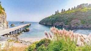 A coastal landscape with a bridge, rocky shore, and vegetation. - Seascape Home - Spacious Coastal Retreat with Ocean Views (Trinidad)