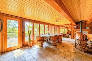 A wooden interior with a large dining table, chairs, and a bar area. - La Casa Del Rio - Serene Riverside Getaway Surrounded by Nature (Salyer)
