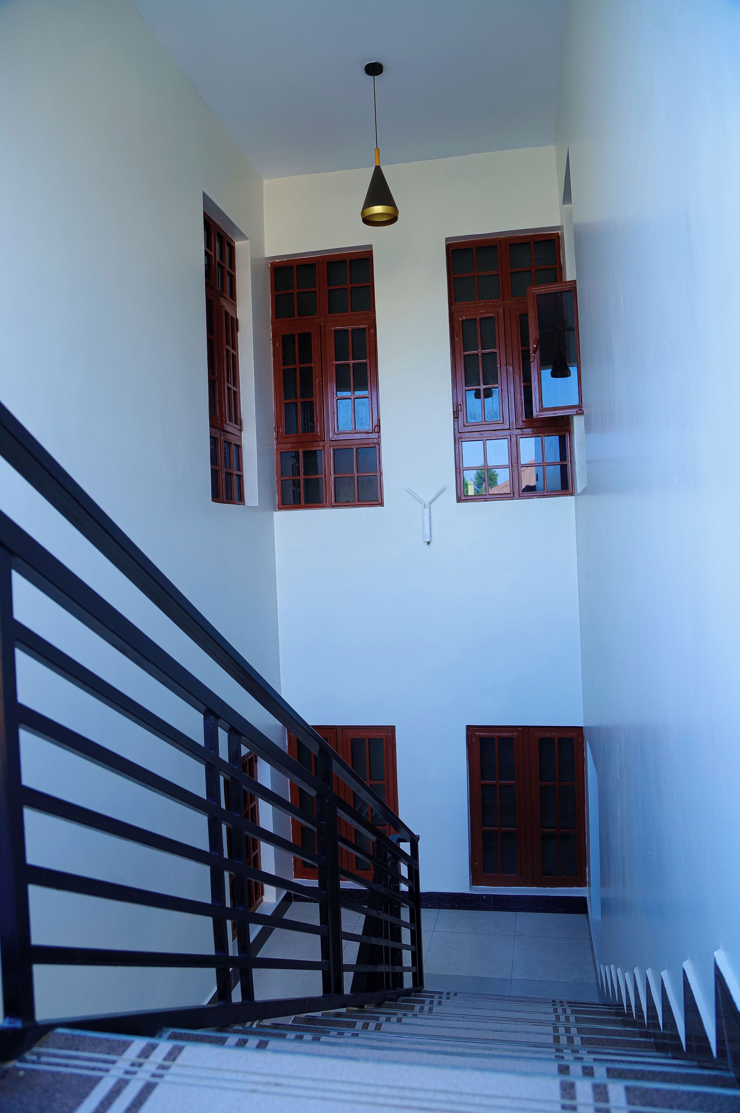 A staircase with a handrail leading to an upper floor.