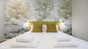 A hotel room with a bed, two pillows, and a wall mural. - Italianway Comfort - Archinto 7/A (Milan)