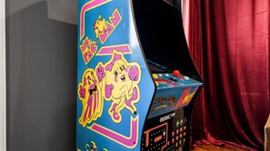 A vintage arcade machine with colorful graphics and a joystick. - Posh Retreat· Heated Pool&HotTub/Game Room/Sleep16 (Houston)