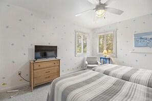 A bedroom with two beds, a TV, a dresser, a chair, and a ceiling fan. - A-B-Ceas: Recently Renovated 5Br (Corolla)