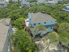 A residential area with multiple houses, one with a visible deck and a chimney. - A-B-Ceas: Recently Renovated 5Br (Corolla)