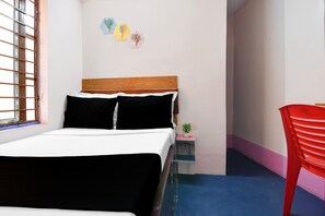 A bedroom with a bed, a bedside table with a plant, a red chair, and a window with bars. - Saver Double Secret Heaven (Barasat)